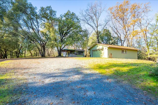 a yellow swimming pool with a lawn chairs under an umbrella