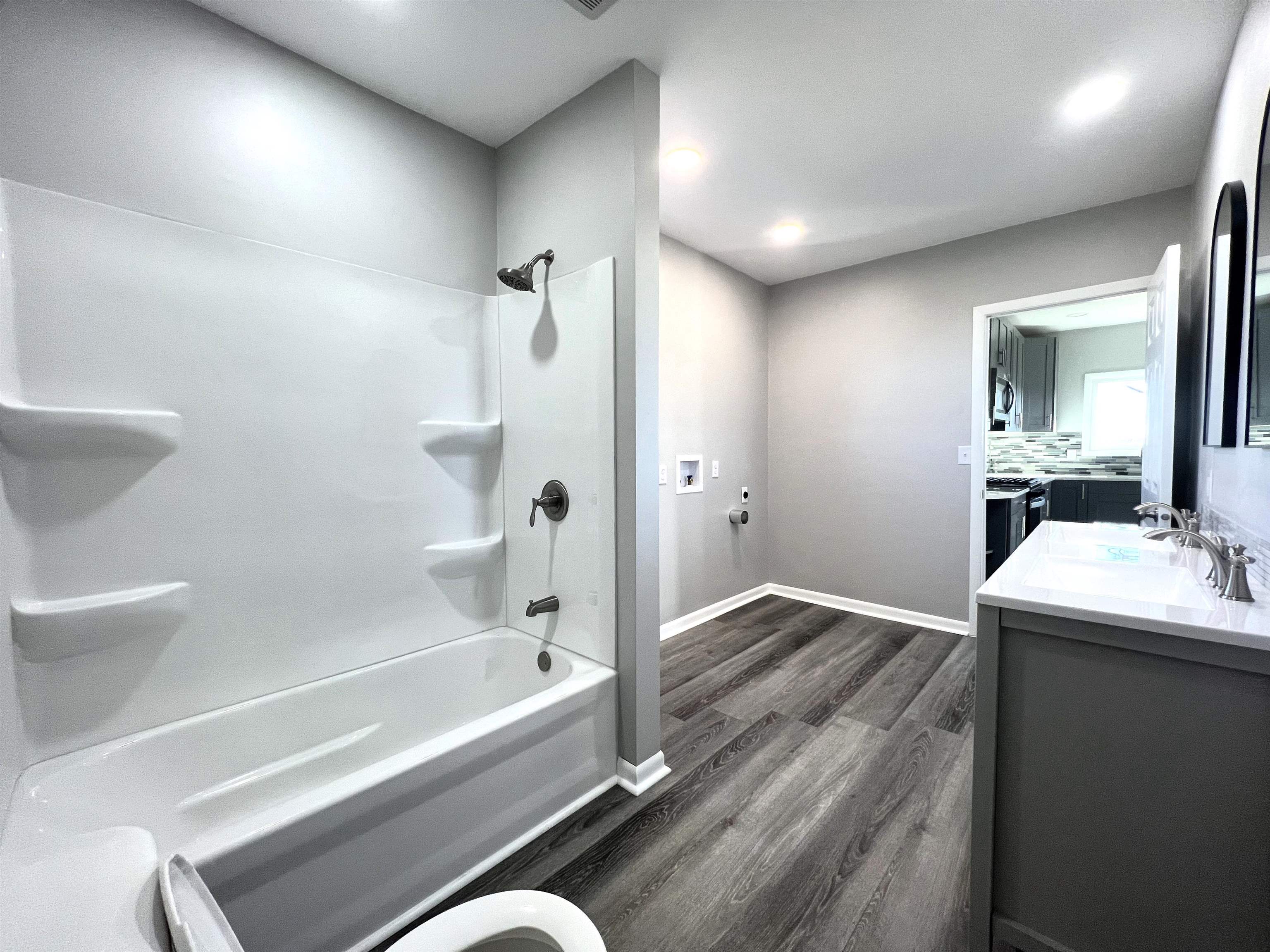 7918 Shirley Road Cherry Valley, IL 61016 - Photo 11 of 36 a bathroom with a tub a sink and mirror