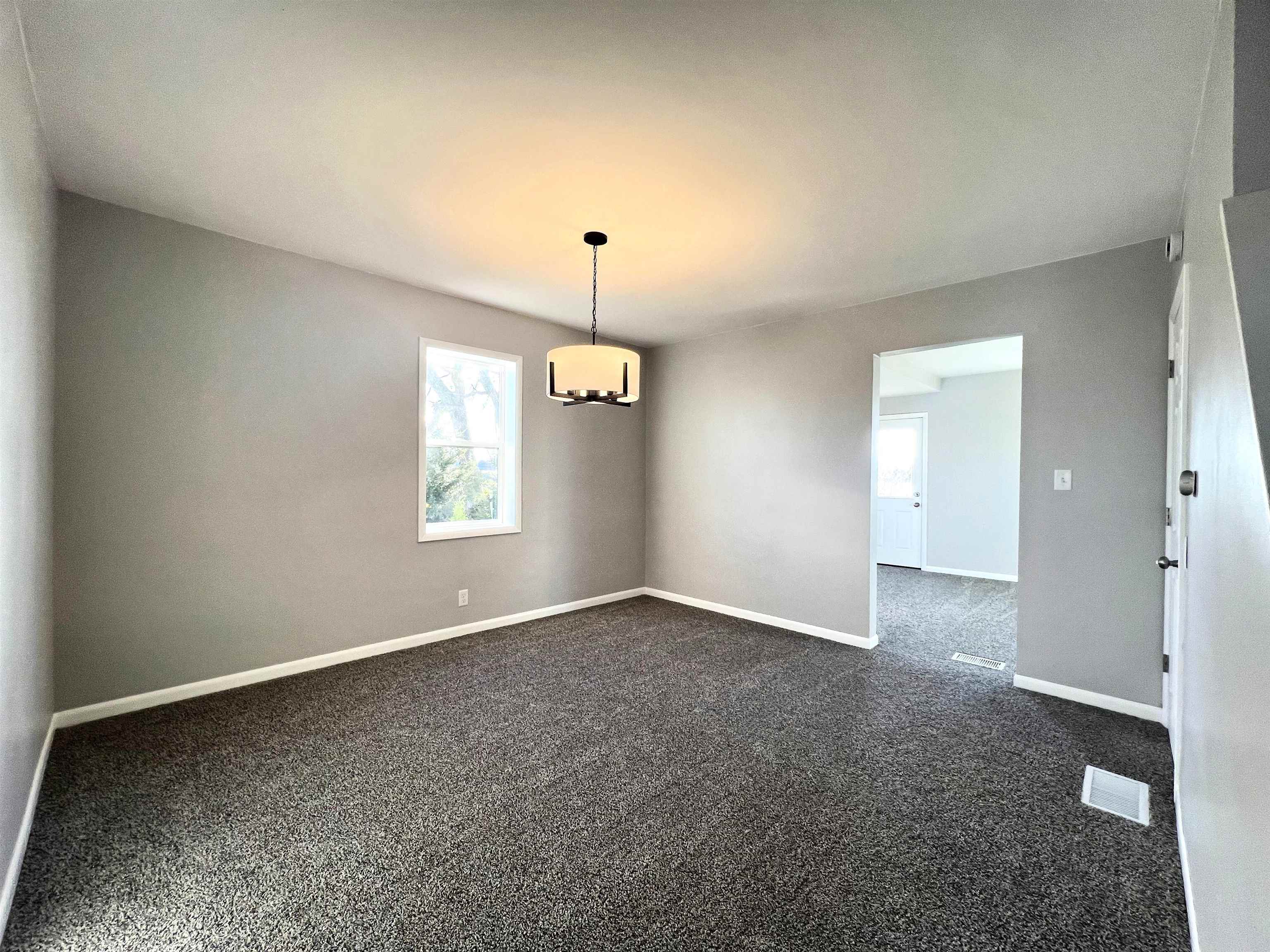 7918 Shirley Road Cherry Valley, IL 61016 - Photo 12 of 36 an empty room with windows and fireplace