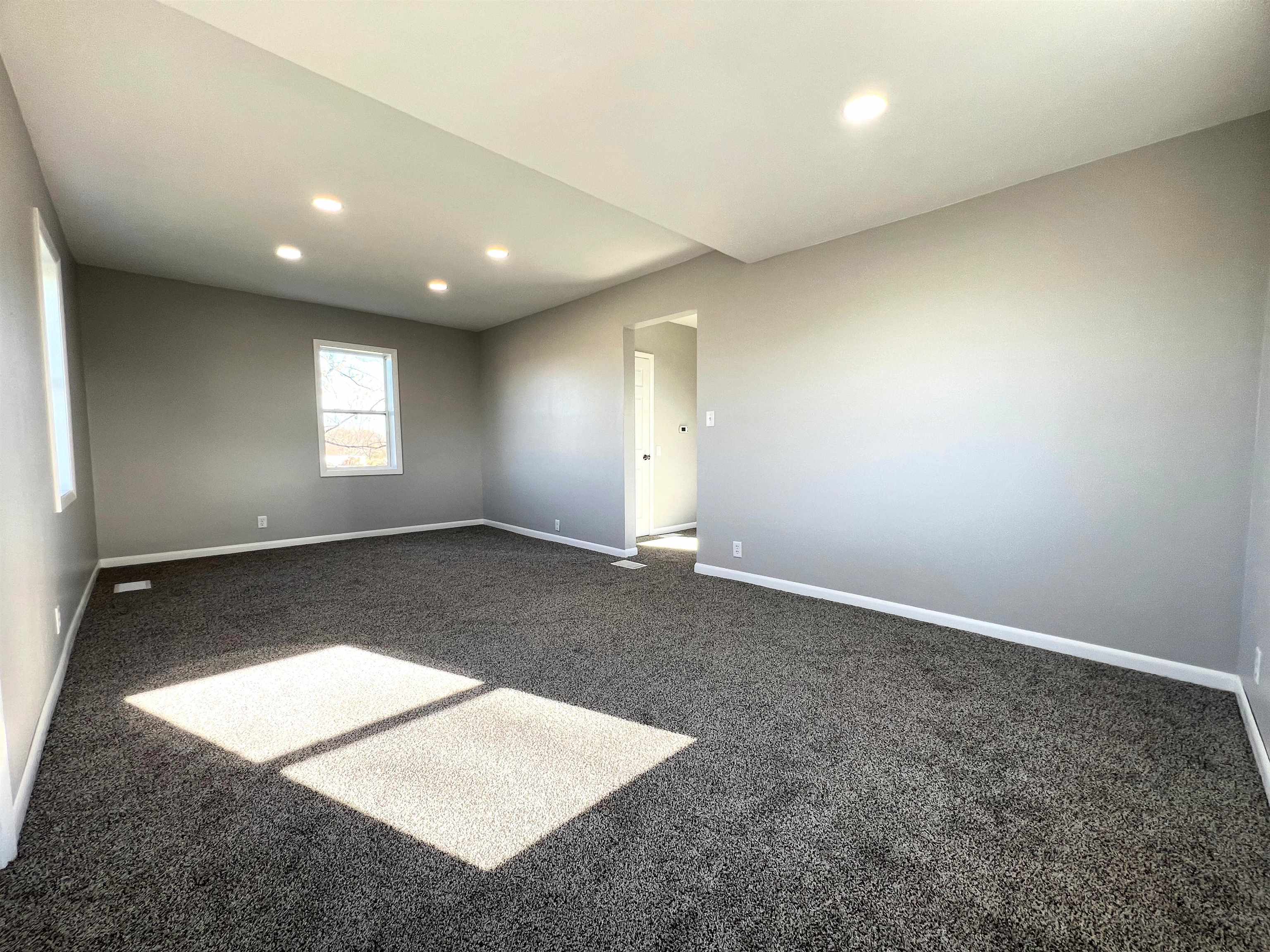 7918 Shirley Road Cherry Valley, IL 61016 - Photo 13 of 36 an empty room with windows and pillars in it