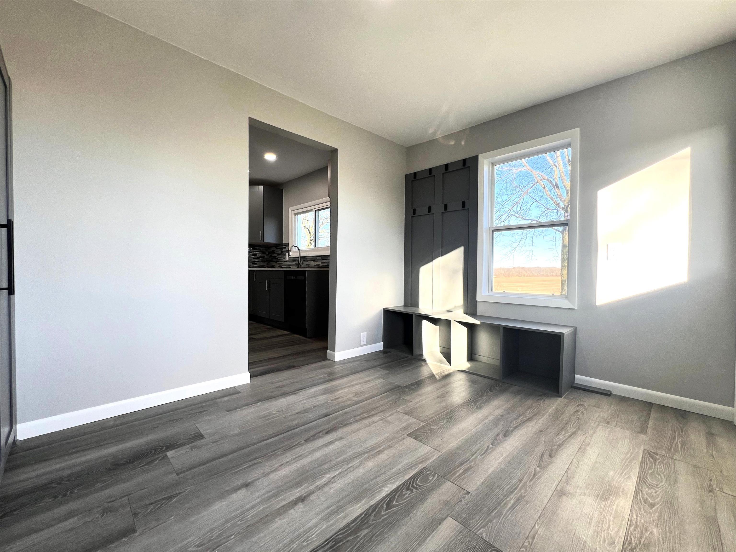 7918 Shirley Road Cherry Valley, IL 61016 - Photo 3 of 36 a view of an empty room with wooden floor and a window