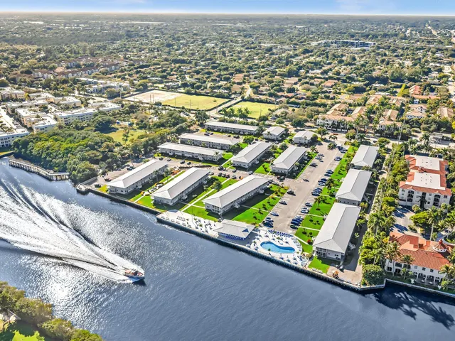an aerial view of residential houses with outdoor space and seating