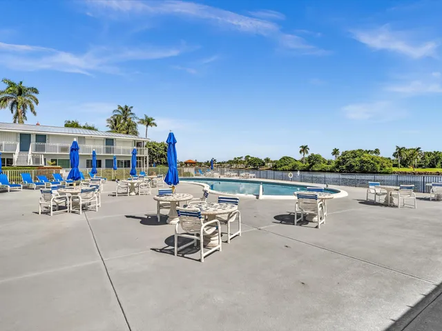 a view of a roof deck with two chairs and a table