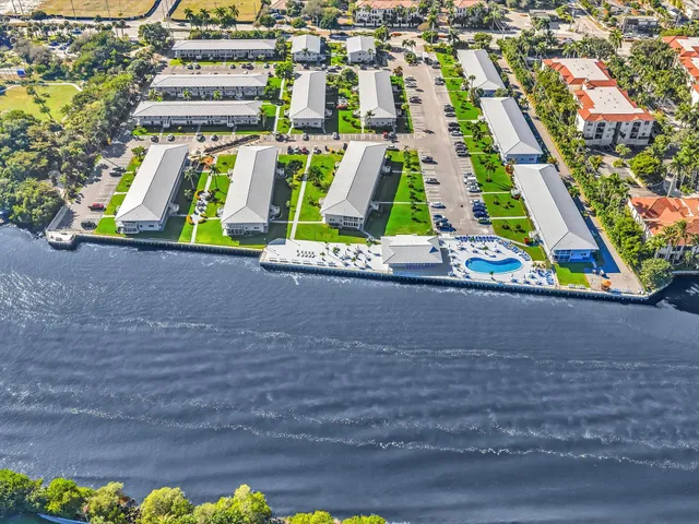 a view of a house with big yard and sitting area