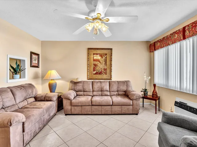 a living room with furniture and a lamp