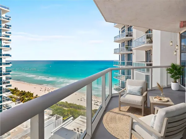 a balcony with an outdoor seating