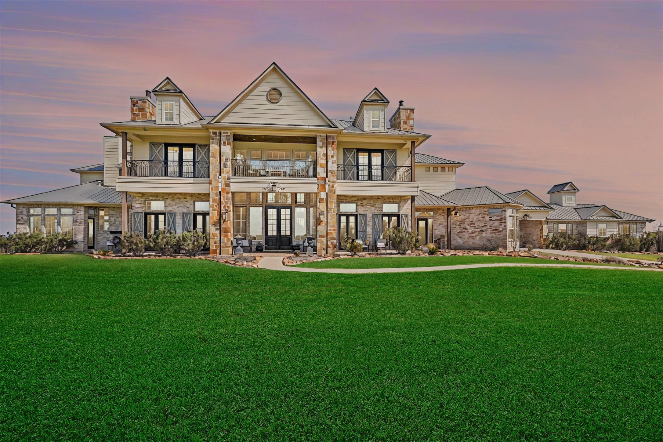 460 Bishop Road Huntsville, TX 77320 - Photo 3 of 50 A breathtaking nighttime view of the main house, beautifully illuminated to highlight its architectural charm, offering a warm and inviting ambiance perfect for evening relaxation.