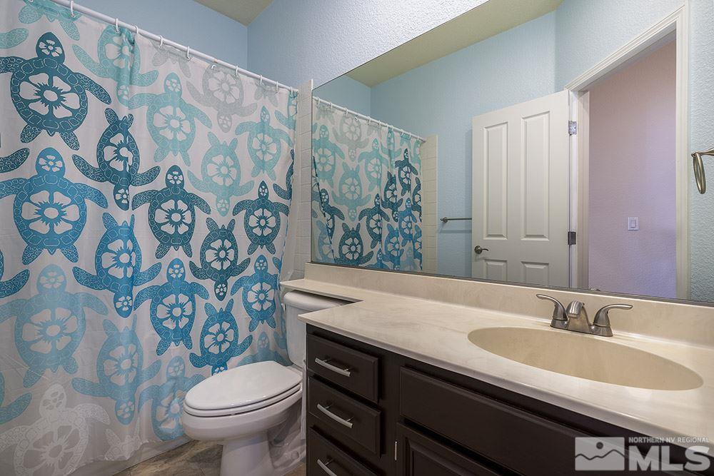 3943 Regal Drive Reno, NV 89503 - Photo 11 of 29 a bathroom with a granite countertop toilet sink and mirror