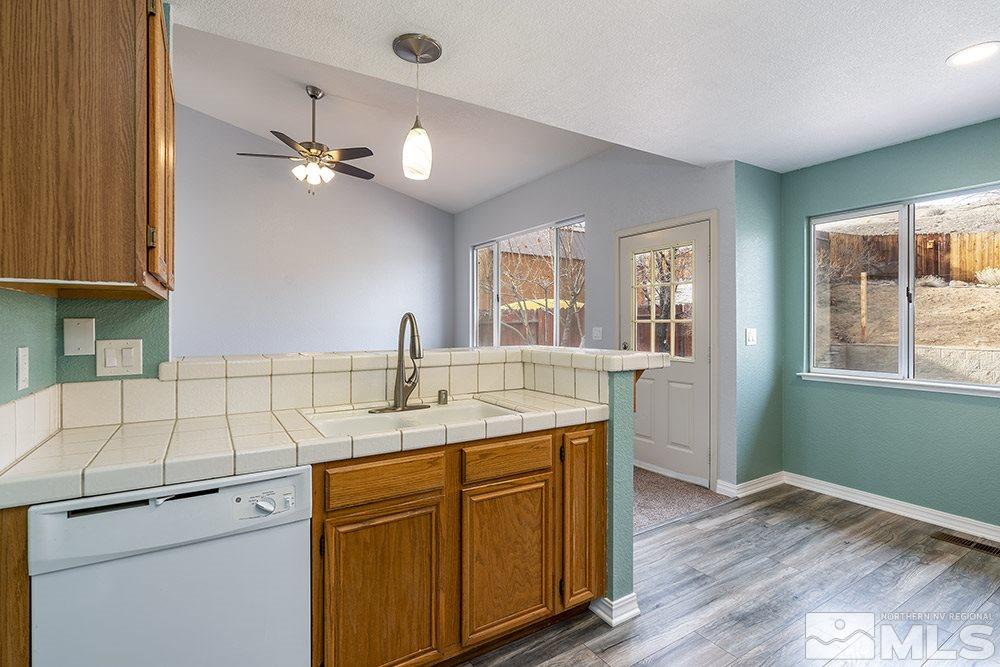 3943 Regal Drive Reno, NV 89503 - Photo 14 of 29 a kitchen with a sink cabinets and wooden floor
