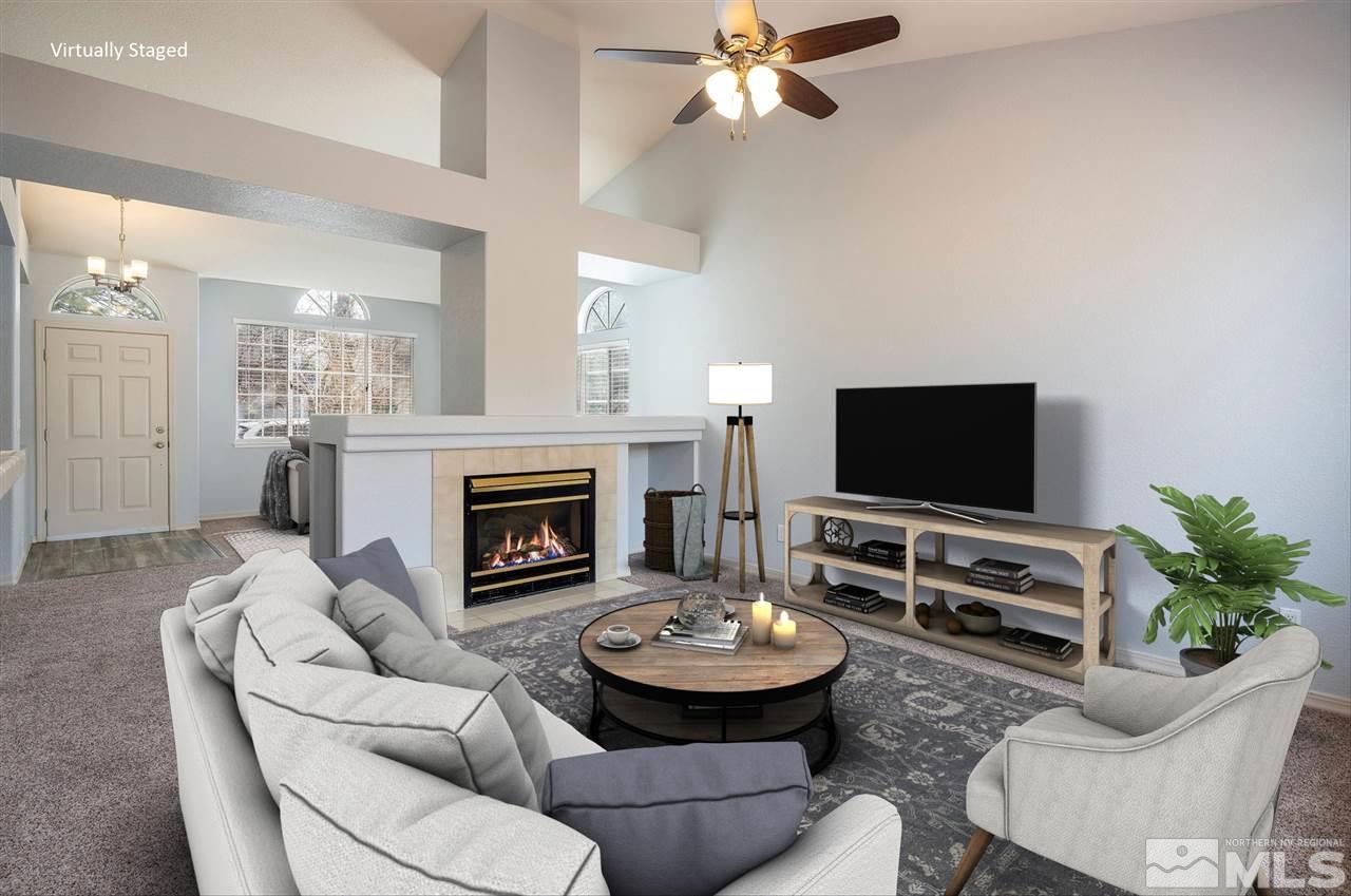 3943 Regal Drive Reno, NV 89503 - Photo 4 of 29 a living room with furniture a fireplace and a flat screen tv