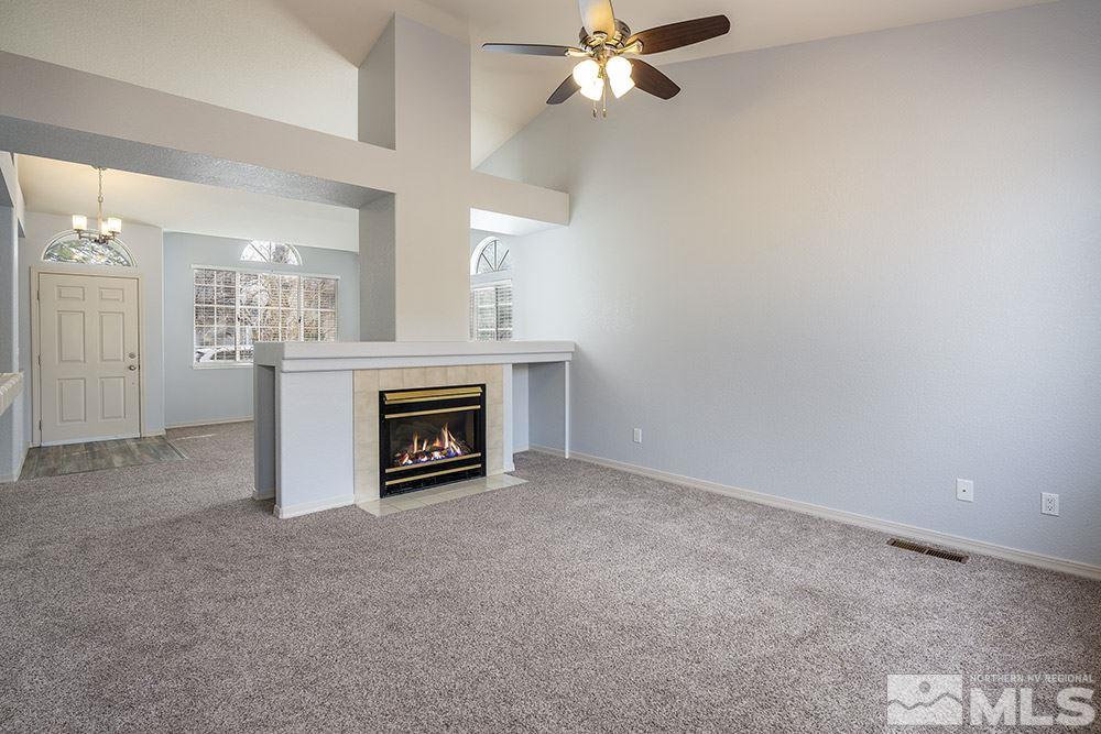 3943 Regal Drive Reno, NV 89503 - Photo 9 of 29 a view of a livingroom with a fireplace and a chandelier fan