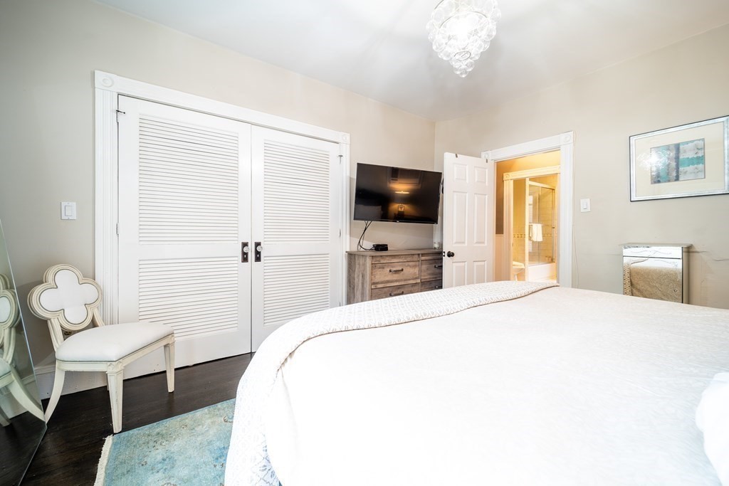 32 Covington Street, Unit SF Boston, MA 02127 - Photo 13 of 27 a bedroom with a bed and a flat screen tv