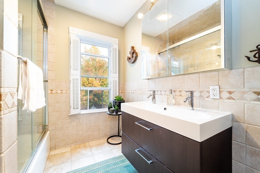 32 Covington Street, Unit SF Boston, MA 02127 - Photo 15 of 27 a bathroom with a sink and a mirror