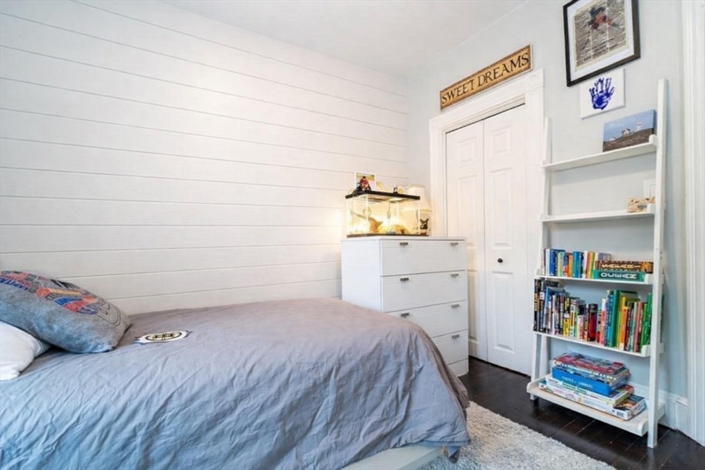 32 Covington Street, Unit SF Boston, MA 02127 - Photo 18 of 27 a bedroom with a bed and a book shelf