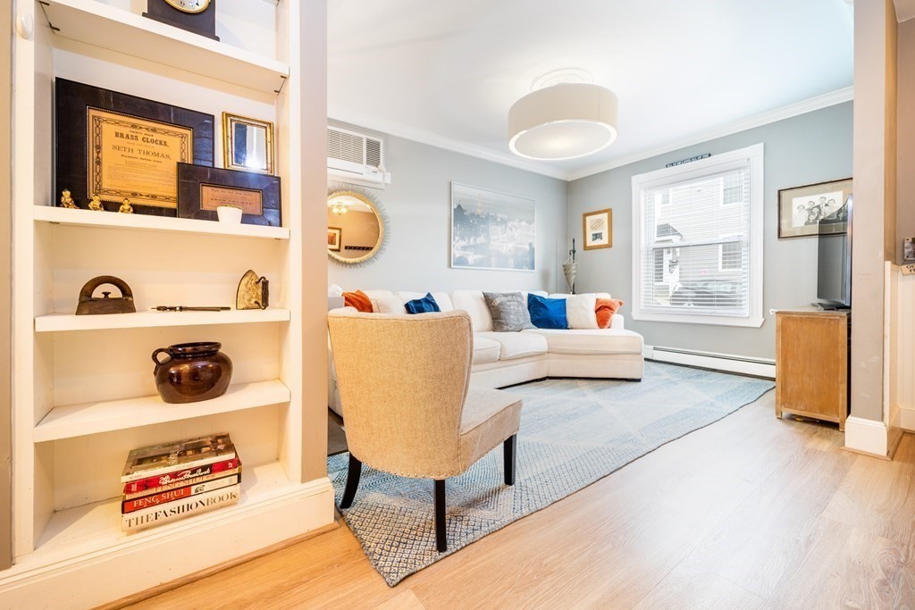32 Covington Street, Unit SF Boston, MA 02127 - Photo 4 of 27 a living room filled with furniture and a lamp