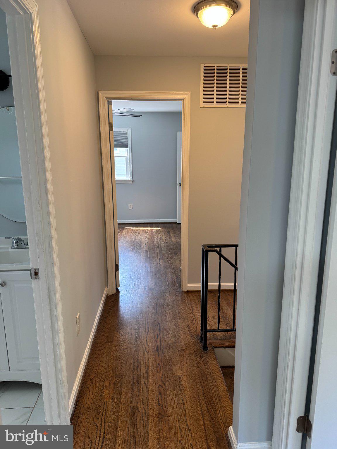 6603 Huntsman Boulevard Springfield, VA 22152 - Photo 31 of 64 Inviting hallway with warm wood floors.