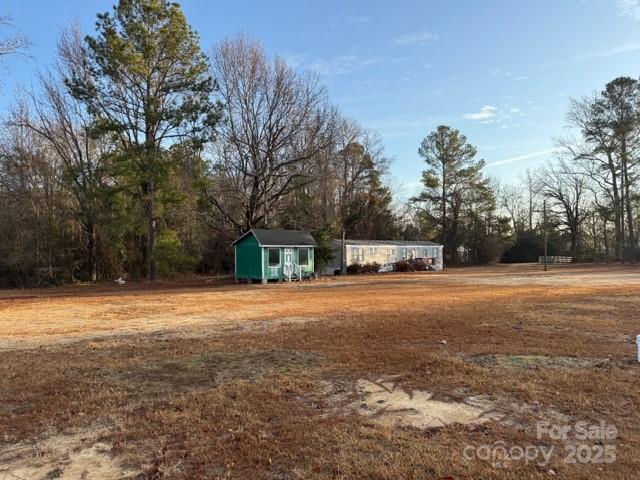 1048 Chesterfield Highway Cheraw, SC 29520 - Photo 9 of 11 a house with trees in front of it