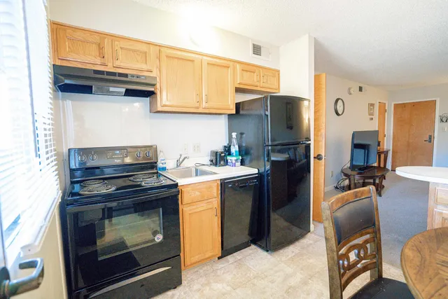 a kitchen with a stove refrigerator and microwave