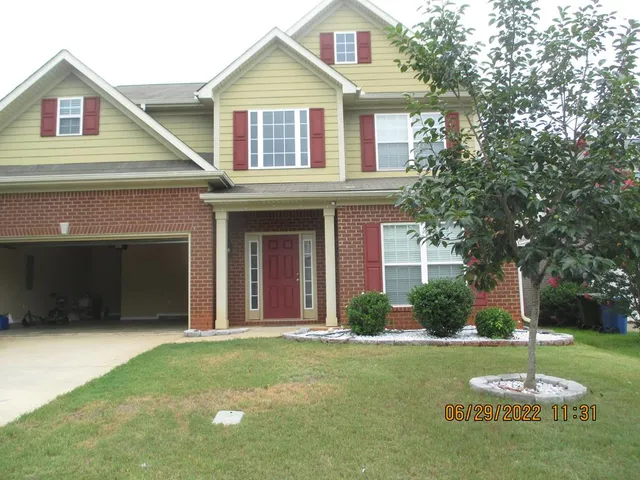 a front view of a house with a yard
