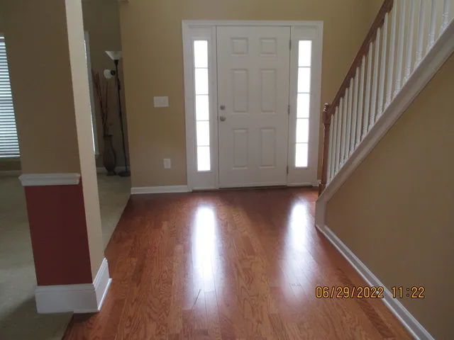 a view of a hallway with wooden floor