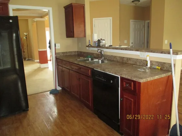 a bathroom with a granite countertop sink a mirror and a shower