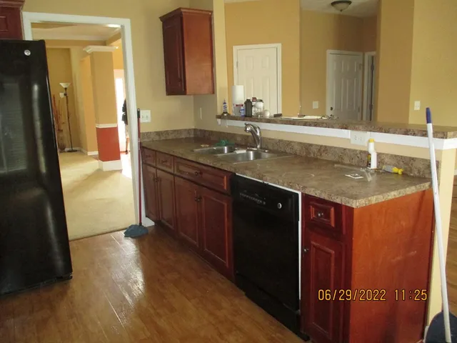 a bathroom with a granite countertop sink a mirror and a shower