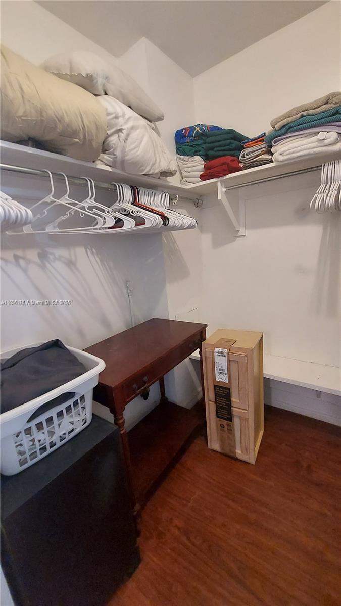 825 Brickell Bay Drive, Unit 443 Miami, FL 33131 - Photo 11 of 26 a room with wooden cabinets and stainless steel appliances