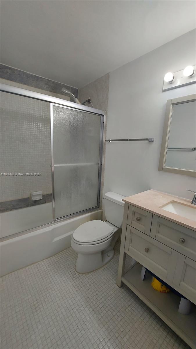 825 Brickell Bay Drive, Unit 443 Miami, FL 33131 - Photo 13 of 26 a bathroom with a toilet a sink and shower