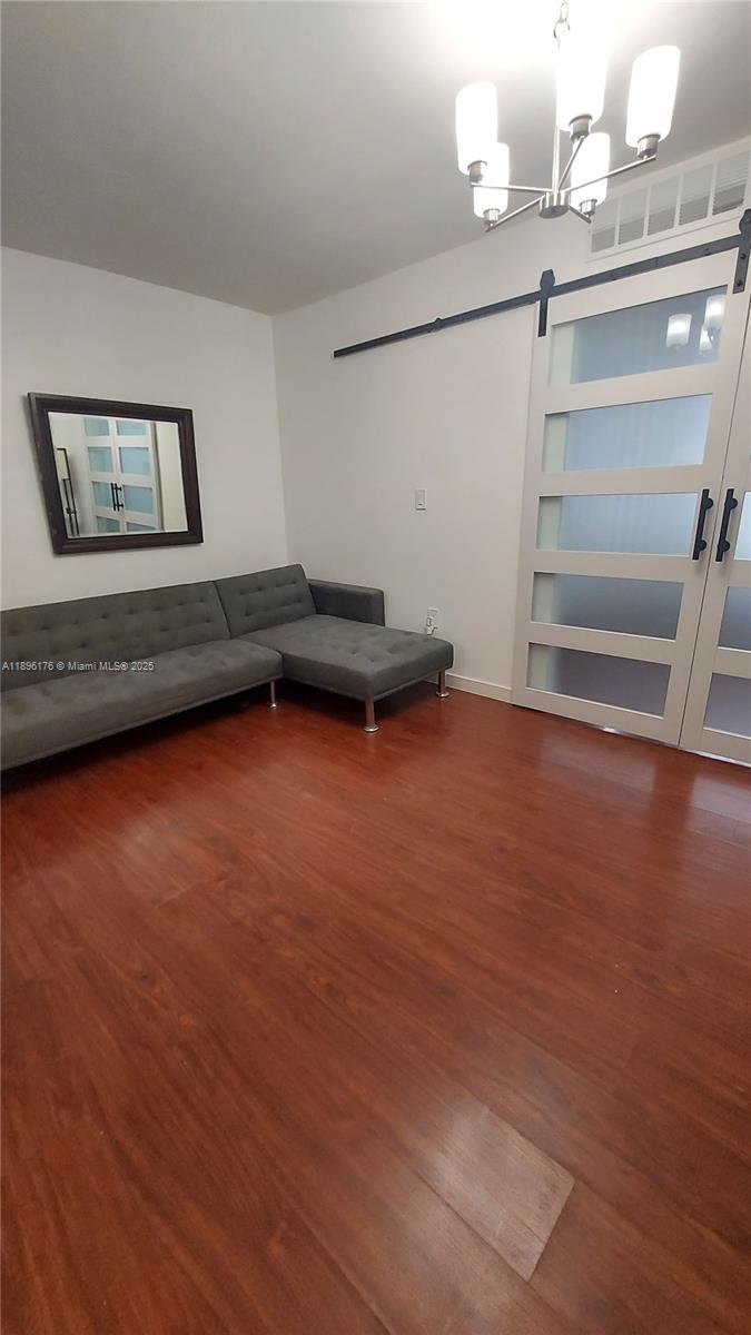 825 Brickell Bay Drive, Unit 443 Miami, FL 33131 - Photo 14 of 26 a view of a room with wooden floor and window