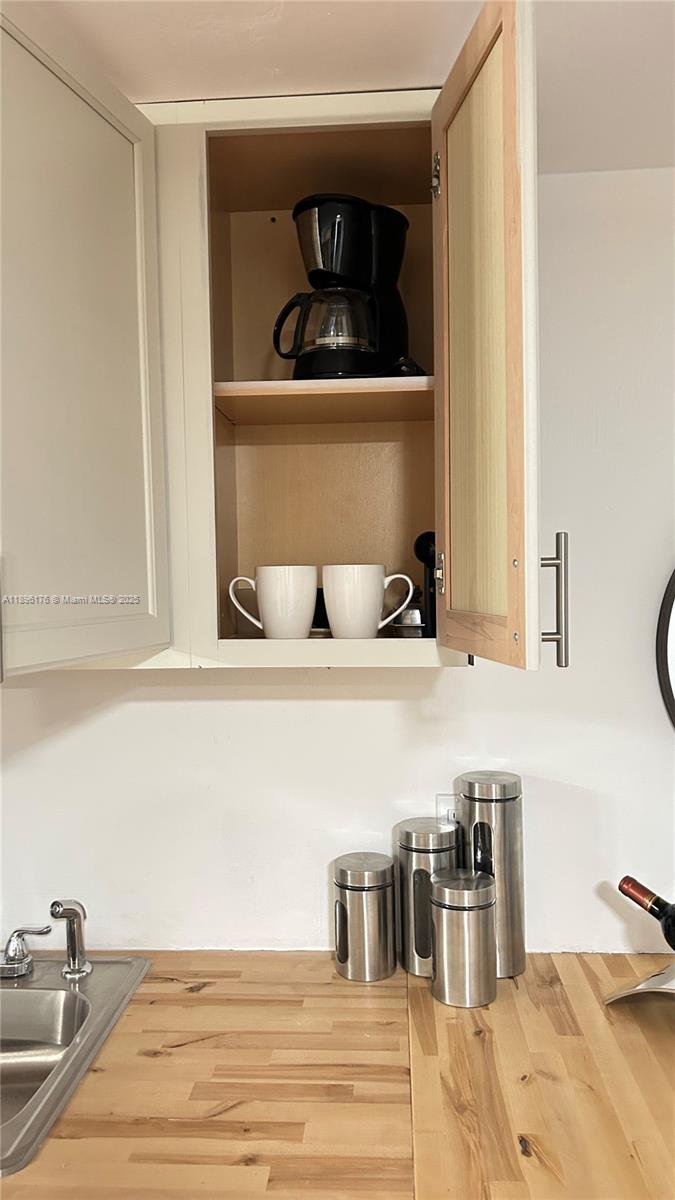 825 Brickell Bay Drive, Unit 443 Miami, FL 33131 - Photo 17 of 26 a kitchen with a oven and cabinets