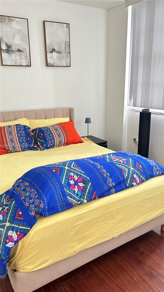 825 Brickell Bay Drive, Unit 443 Miami, FL 33131 - Photo 20 of 26 a bed sitting in a bedroom next to a window