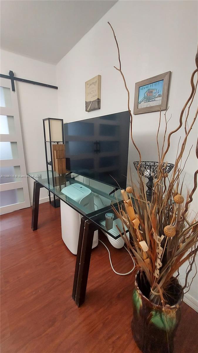 825 Brickell Bay Drive, Unit 443 Miami, FL 33131 - Photo 2 of 26 a living room with furniture and a wooden floor