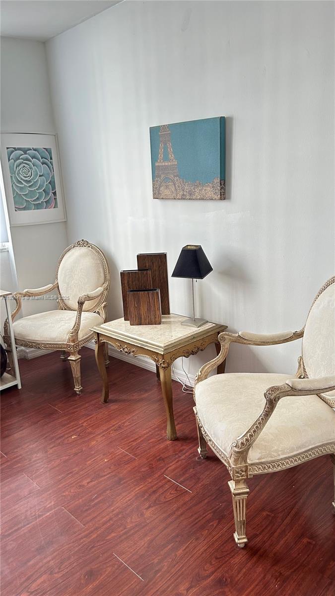 825 Brickell Bay Drive, Unit 443 Miami, FL 33131 - Photo 21 of 26 a living room with furniture and a chair