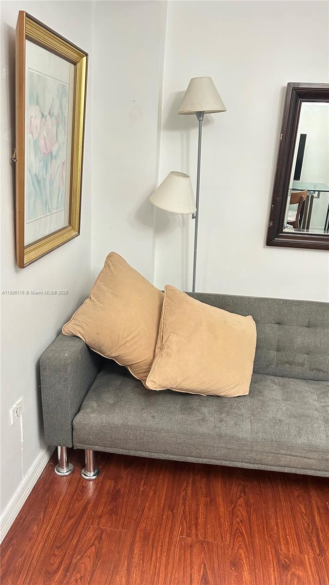 825 Brickell Bay Drive, Unit 443 Miami, FL 33131 - Photo 26 of 26 a living room with a couch and a lamp on table