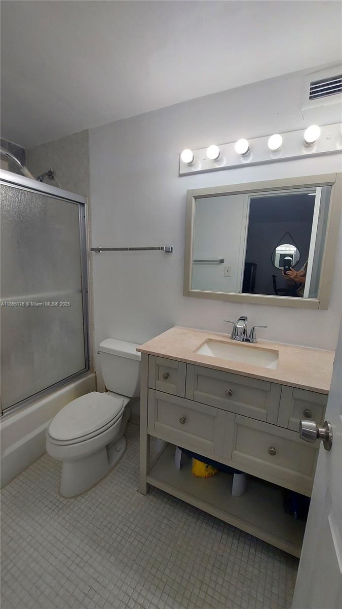 825 Brickell Bay Drive, Unit 443 Miami, FL 33131 - Photo 8 of 26 a bathroom with a toilet a sink and mirror