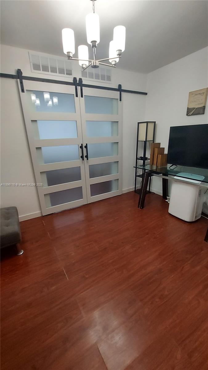 825 Brickell Bay Drive, Unit 443 Miami, FL 33131 - Photo 9 of 26 a living room with furniture and a flat screen tv