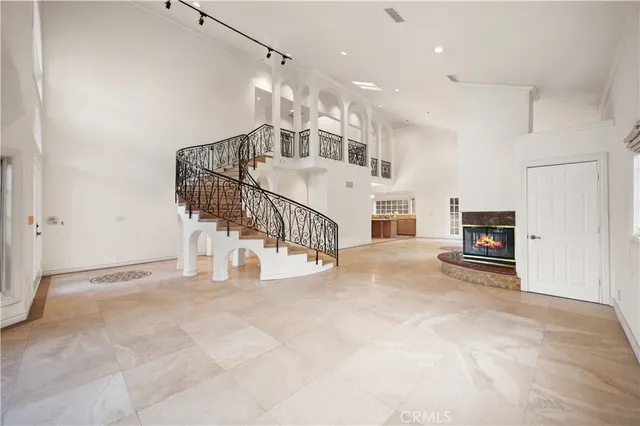 a view of a livingroom with entryway and stairs