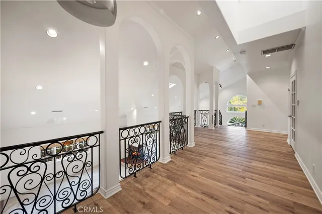 a view of a hallway with wooden floor