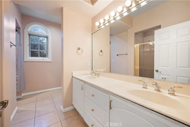 a bathroom with a double vanity sink and a mirror