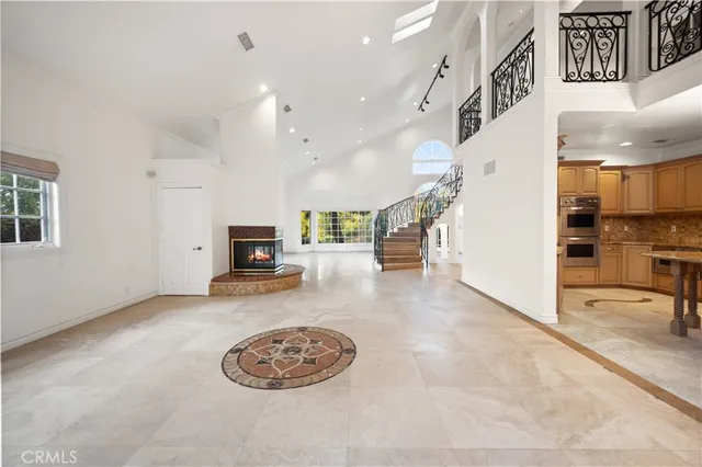 a living room with furniture and a kitchen