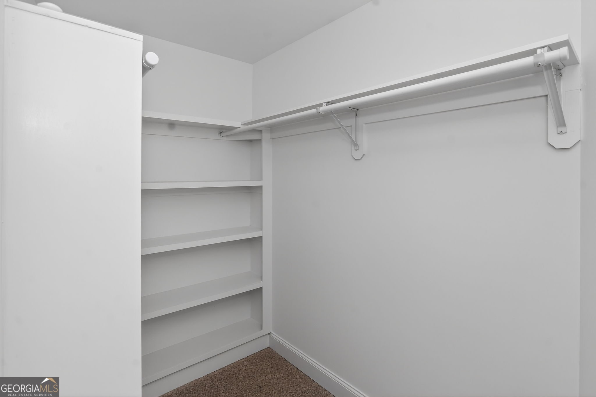 1229 Chappell Mill Road Jackson, GA 30233 - Photo 49 of 55 a view of walk in closet with empty racks