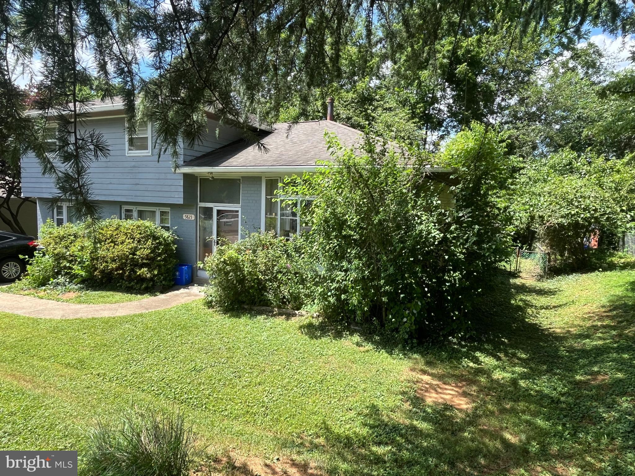 5823 Folkstone Road Bethesda, MD 20817 - Photo 3 of 3 a front view of a house with garden