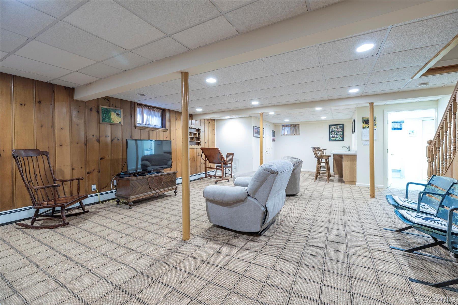 15 Baylis Road Rockville Centre, NY 11570 - Photo 15 of 20 a living room with furniture a table and chairs