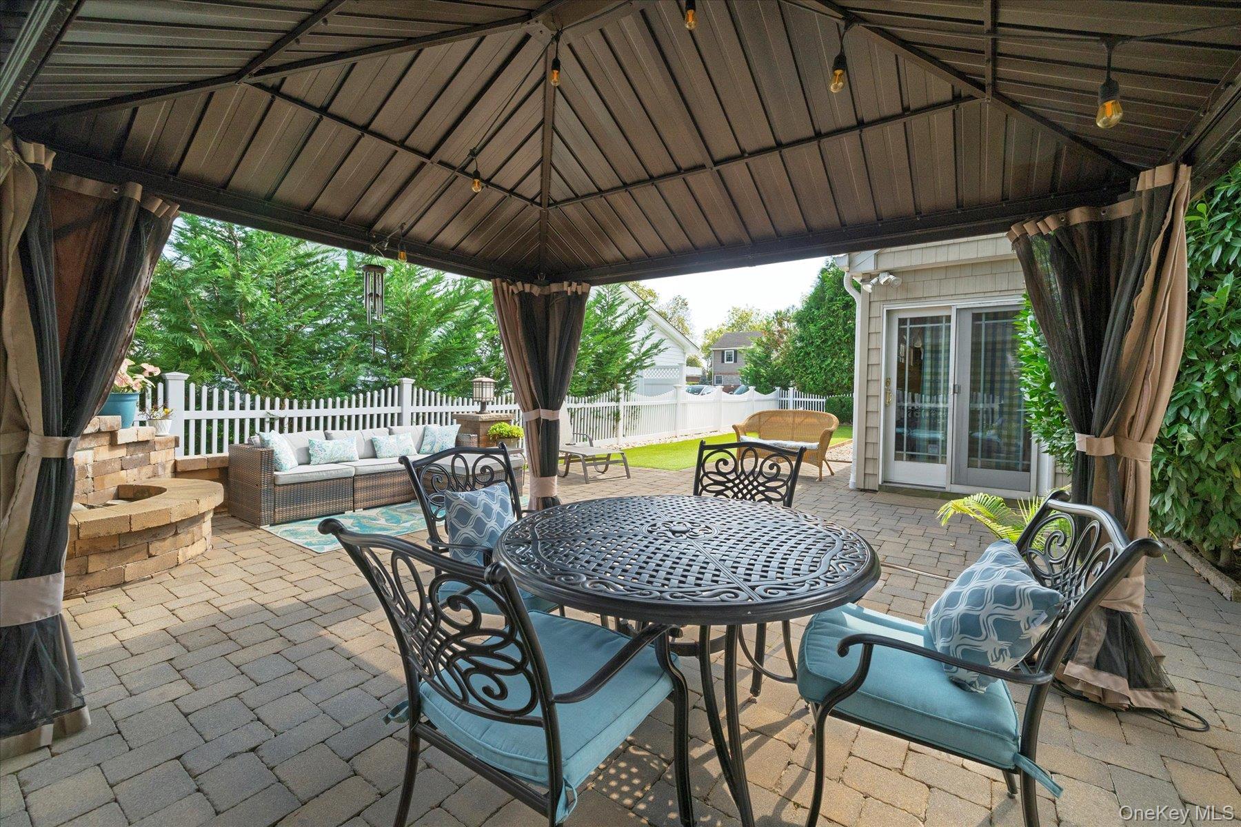 15 Baylis Road Rockville Centre, NY 11570 - Photo 17 of 20 a view of a patio with a table chairs and a umbrella