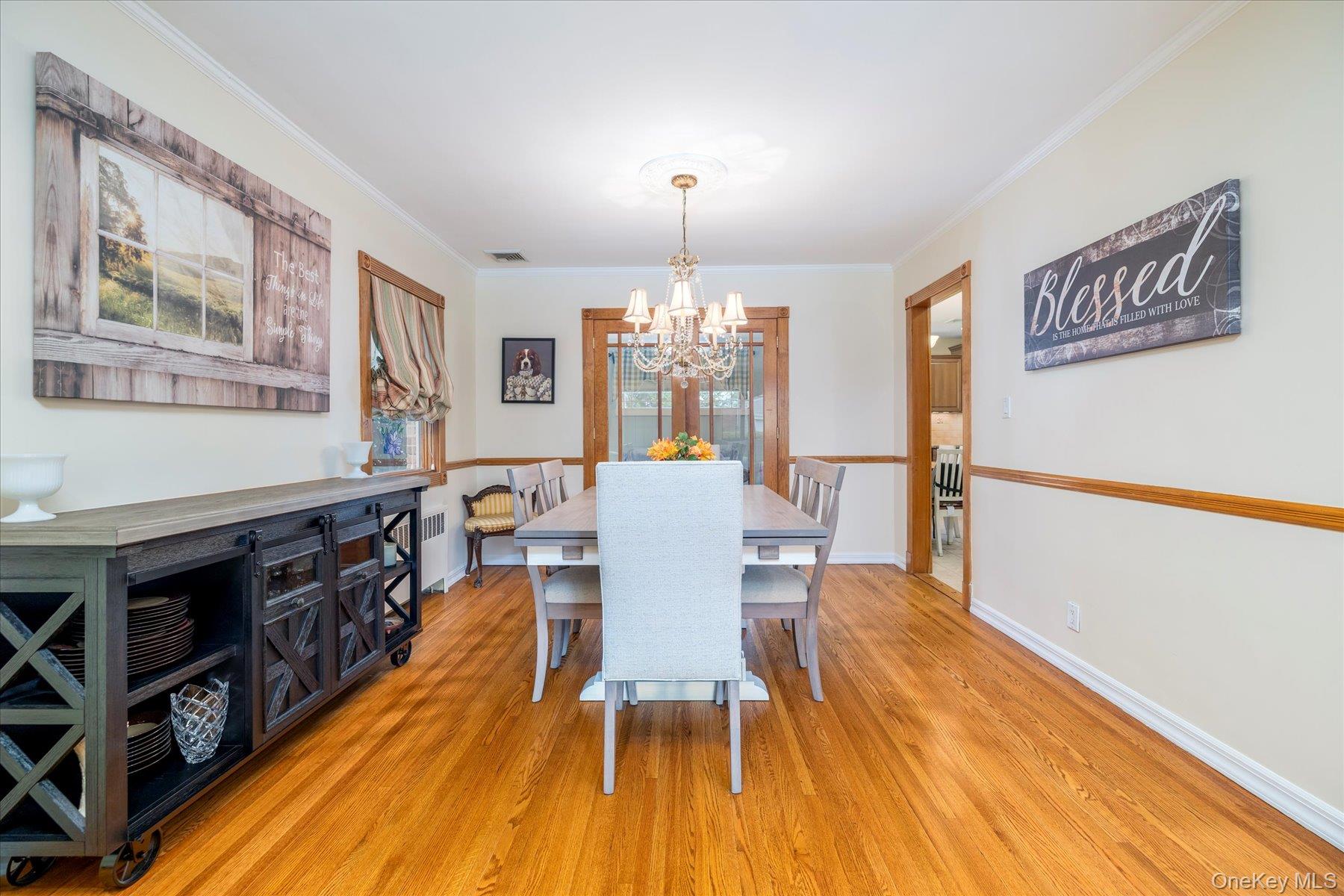 15 Baylis Road Rockville Centre, NY 11570 - Photo 4 of 20 a view of a dining room with furniture a chandelier and wooden floor