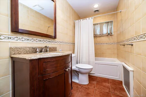 a bathroom with a sink toilet a mirror and shower