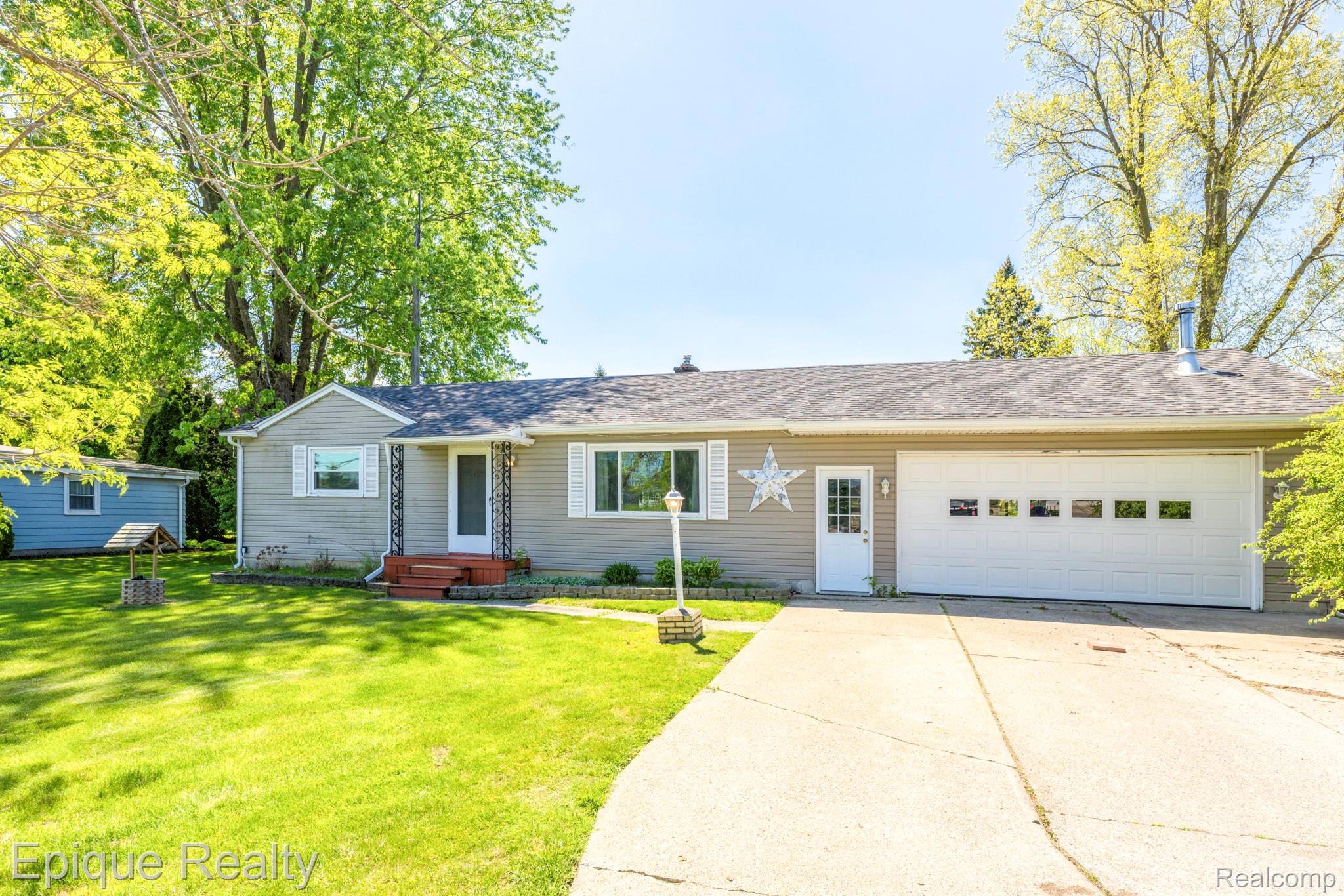 11110 Davison Road Davison, MI 48423 - Photo 1 of 65 Ranch-style home featuring a garage, driveway, roof with shingles, and a front lawn