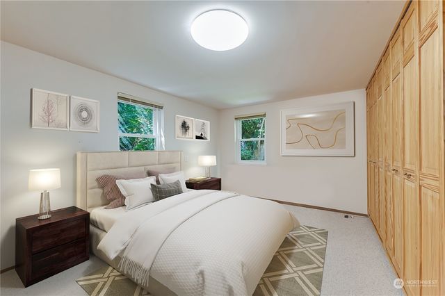 a bedroom with a bed and a painting on the wall