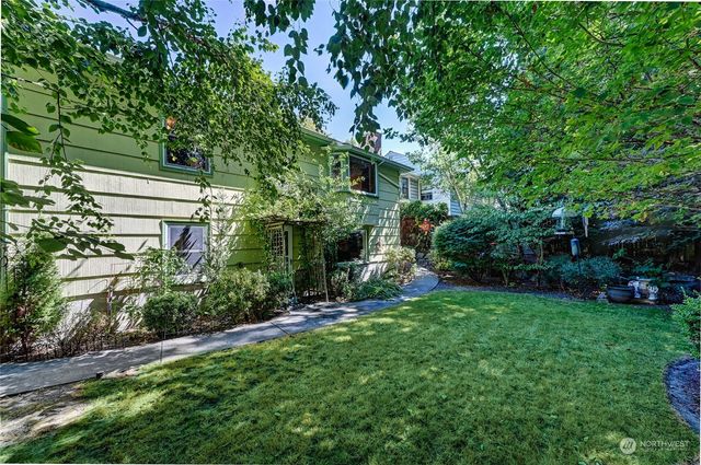 a view of green field with trees in the background