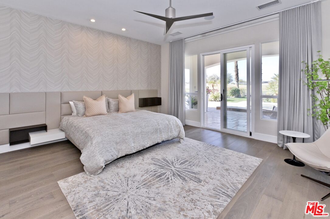 380 Loch Lomond Road Rancho Mirage, CA 92270 - Photo 13 of 39 a bedroom with a large bed and a large window